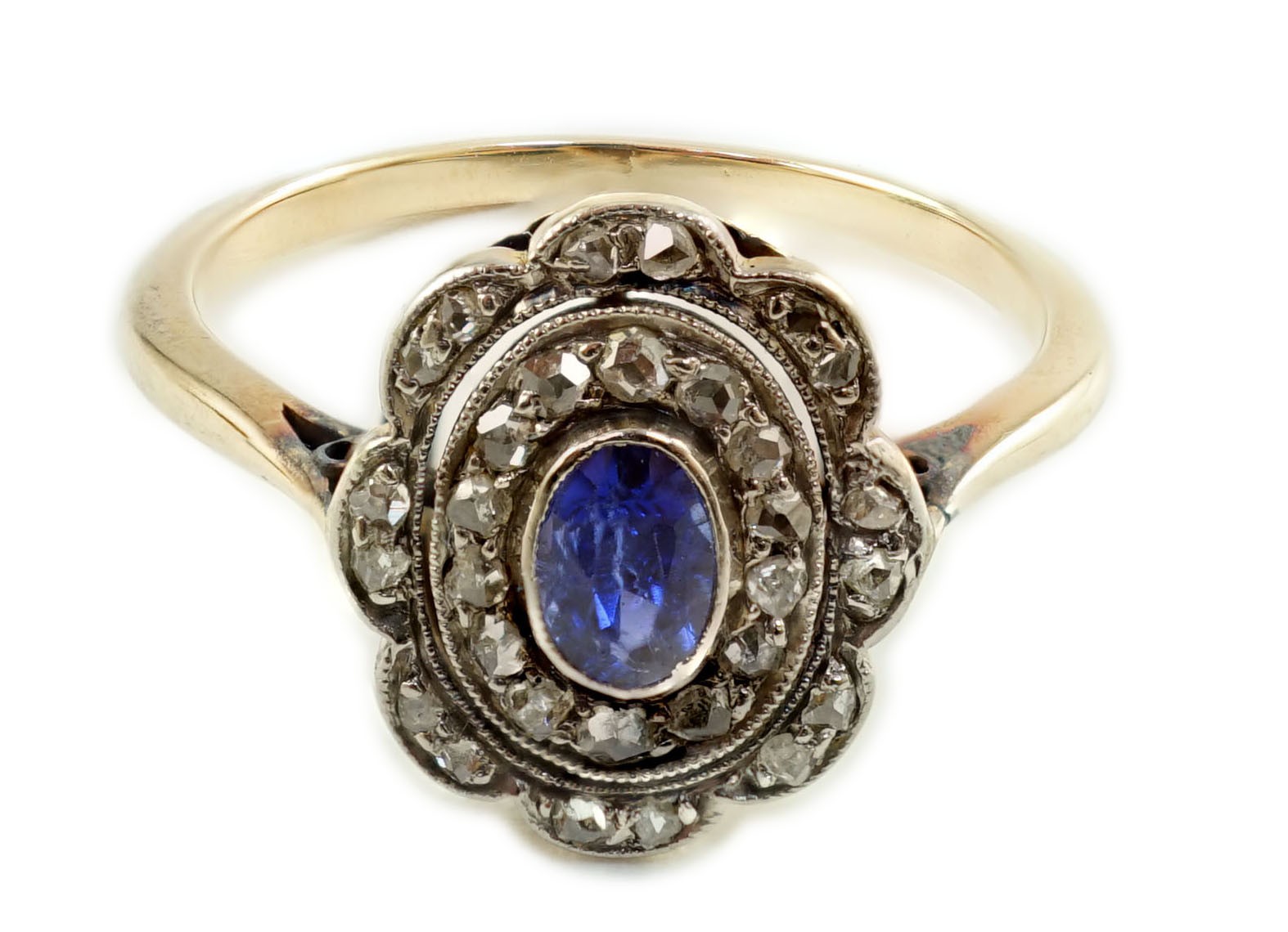 An early 20th century gold, sapphire and millegrain set rose cut diamond set oval cluster ring